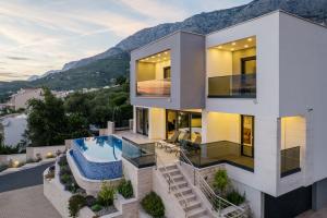 an aerial view of a house with a swimming pool at Villa LUX 55 in Tučepi