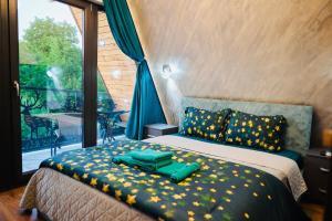 a bedroom with a bed with green sheets and a window at A Frame Poalele Transalpinei in Novaci-Străini