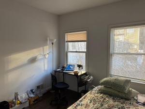 a bedroom with a bed and a desk with a laptop at Evanshouse in Stafford