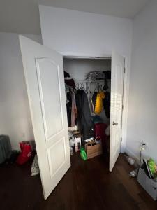 an open white door in a room with a closet at Evanshouse in Stafford