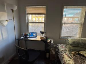 a desk with a laptop on it in a bedroom at Evanshouse in Stafford