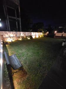a park bench sitting in a yard at night at Airport Luxury Villa 65 - Negombo-Airport Transit Guest in Negombo
