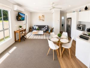a kitchen and living room with a table and chairs at Between the Blue Studio in Blacksmiths