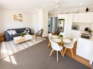 a living room with a table and a couch at Between the Blue Studio in Blacksmiths +13 photos