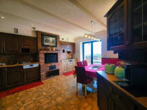 a kitchen with a table and red chairs in a room at Le Nid d'aigle apt 405 Leysin centre avec forfait piscine sauna jacuzzi en option in Leysin
