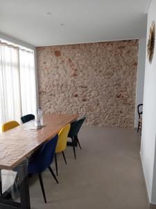 a dining room with a wooden table and chairs at Beau séjour in Pedreguer