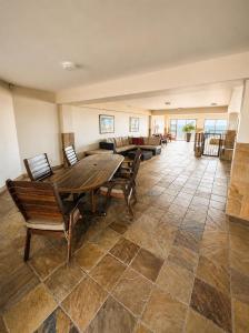 a large living room with a wooden table and chairs at Klein paradys Jeffreys bay in Jeffreys Bay