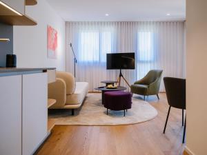 a living room with a couch and two chairs at THE FLAG Lugano - Self Check-in in Massagno