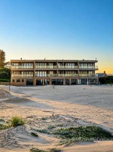a large building in the middle of a beach at Klein paradys Jeffreys bay in Jeffreys Bay