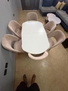 a white table and chairs in a living room at Casa bushi in Kamëz
