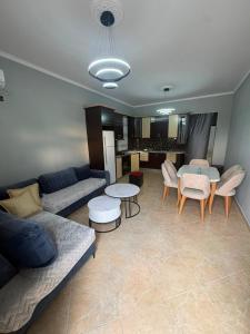 a living room with a couch and a table at Casa bushi in Kamëz