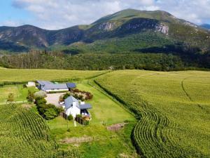 an aerial view of a farm with mountains in the background at Kiekiebos in Wilderness