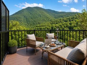 a balcony with a couch and a table with a laptop at Qafqaz Falcon Chalet in Gabala