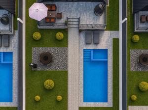 an overhead view of a backyard with a pool and an umbrella at Qafqaz Falcon Chalet in Gabala