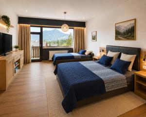 a bedroom with a bed and a couch and a television at Dachstein Blick in Bad Goisern
