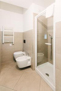 a bathroom with a shower and a toilet and a sink at U Genova in Genoa +28 photos