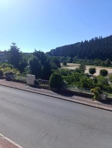 an empty road next to a field and trees at chez MAG et YANN in La Séauve-sur-Semène