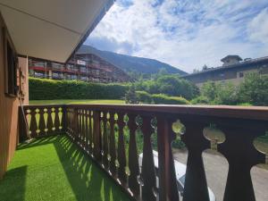a balcony with a fence and green grass at Residence Isabella - By Care Concierge in Saint-Gervais-les-Bains