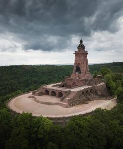 a large stone monument in the middle of a forest at Kleine Südharz Auszeit in Heringen