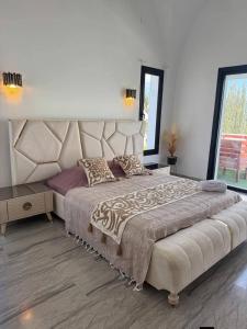 a bedroom with a large bed with a large headboard at Villa Sky in Bin Rhilouf +17 photos