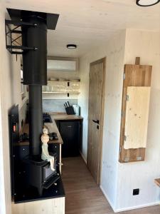 a kitchen with a black stove in a room at Maringotka Na mezi in Maršovice