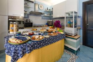 a buffet of food on a counter in a kitchen at Athena Bed & Breakfast in San Vito lo Capo +31 photos