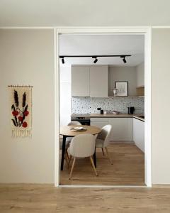 a kitchen and dining room with a table and chairs at Dunavska panorama in Golubac