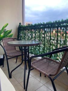 a table and chairs on a balcony with a view at The Cozy Corner Studio in Ruaka