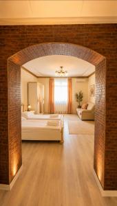 a large bedroom with a large bed and a brick wall at Pensiunea Cardinal in Sibiu