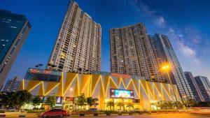 a building in a city with tall buildings at Vinhomes D'capitale Hanoi Opus in Hanoi