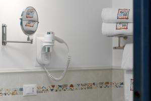 a bathroom with a blow dryer and towels at Athena Bed & Breakfast in San Vito lo Capo