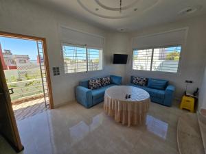 a living room with a couch and a table at Villa Sabrina in Moulay Bousselham