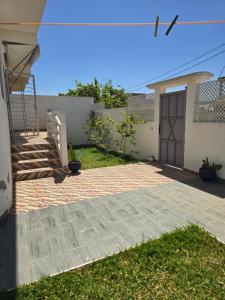 a house with a brick walkway and a garage at Villa Sabrina in Moulay Bousselham