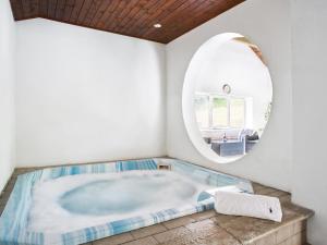a large bath tub in a room with a mirror at Shippon - Ukc9529 in Barnstaple