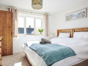 a bedroom with two beds and a window at Willow - Ukc9530 in Barnstaple