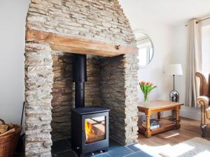 a wood stove in a living room with a stone wall at Willow - Ukc9530 in Barnstaple