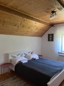 a bedroom with a bed and a wooden ceiling at Hillside in Slavske +86 photos