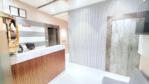 a bathroom with a shower and a glass door at Hotel Planet villa in Ahmedabad