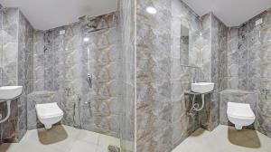 a bathroom with two sinks and two toilets at Hotel Planet villa in Ahmedabad