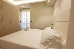 a bedroom with a large white bed and a window at Hotel Twins in Vasto