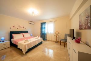 a bedroom with a bed and a television in it at Melograno in Markopoulo