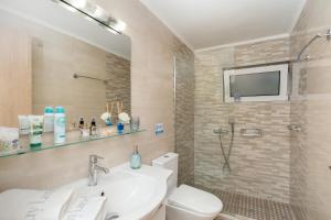 a bathroom with a toilet and a sink and a shower at Melograno in Markopoulo +22 photos