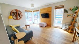 a living room with a couch and a table at Tottenham Spur Hideaway in London