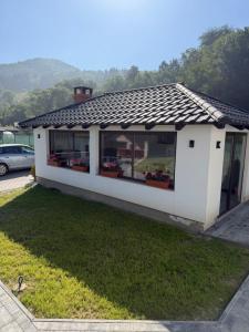 a small white house with a roof at Casa Lye in Vişeu de Sus