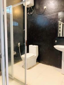 a bathroom with a toilet and a sink at City Hub Transit in Katunayaka +37 photos