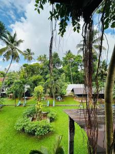 a view of a park with a bench and palm trees at City Hub Transit in Katunayaka