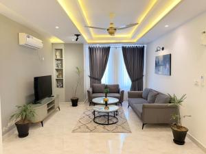 a living room with a couch and a tv at 2 BHK Stayloom 218 in Rawalpindi