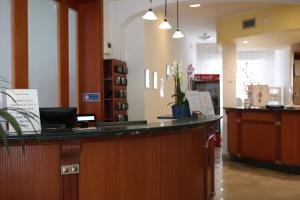 a lobby with a reception desk and a counter at Hotel Adriatico in Bellaria-Igea Marina