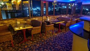 a restaurant with tables and chairs in a bar at Anadolu Hotel & Restaurant & Spa in Batumi +26 photos