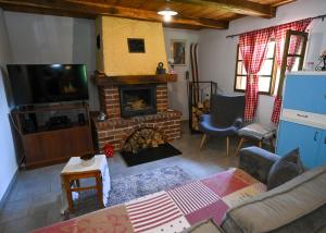 a living room with a fireplace and a tv at Kuća za odmor Josipa in Klanjec